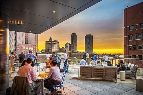 rooftop restaurant with people sitting at sunset